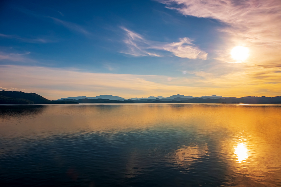 Sunrise-over-Reflective-Lake-iStock-1140746153.jpg